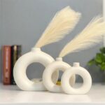 White ceramic donut flower vase with hollow circular design for modern home decor