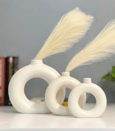 White ceramic donut flower vase with hollow circular design for modern home decor