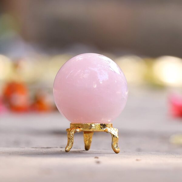 Natural pink rose quartz sphere with metal decorative stand
