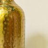 Shiny metallic gold vase handcrafted by artisans with hammered detailing