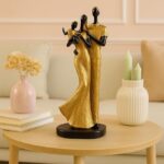 Stylish golden black resin couple statue with child décor piece