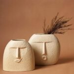 Unique sculptural ceramic vase with playful smiling face design