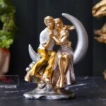 Romantic couple statue sitting on crescent moon showpiece