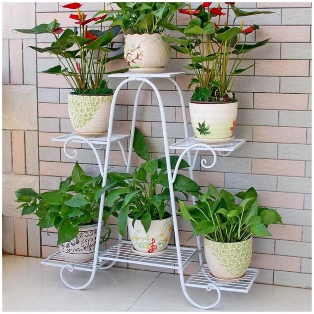 Plant stand with multiple flower pots arranged indoors.