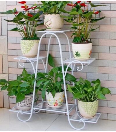 Plant stand with multiple flower pots arranged indoors.