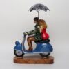 Artistic scooter couple figurine symbolizing romance and travel