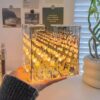 Modern night light with tulip reflection inside mirror cube