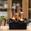 Candle holder with decorative resin tabletop water fountain