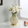 Golden metal flower vase with sparkling crystal