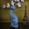 Cute and modern handicraft resin art cat figurine placed on a wooden table