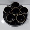 Stylish ceramic cup on decorative metal tray for kitchen use