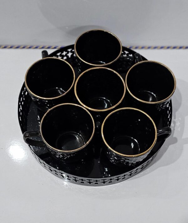 Stylish ceramic cup on decorative metal tray for kitchen use