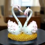 Pair of marble swan showpieces in glossy pink and white for home décor