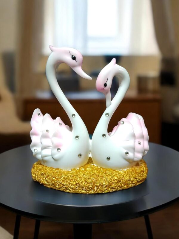 Pair of marble swan showpieces in glossy pink and white for home décor