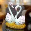 Glossy pink and white marble swan figurines