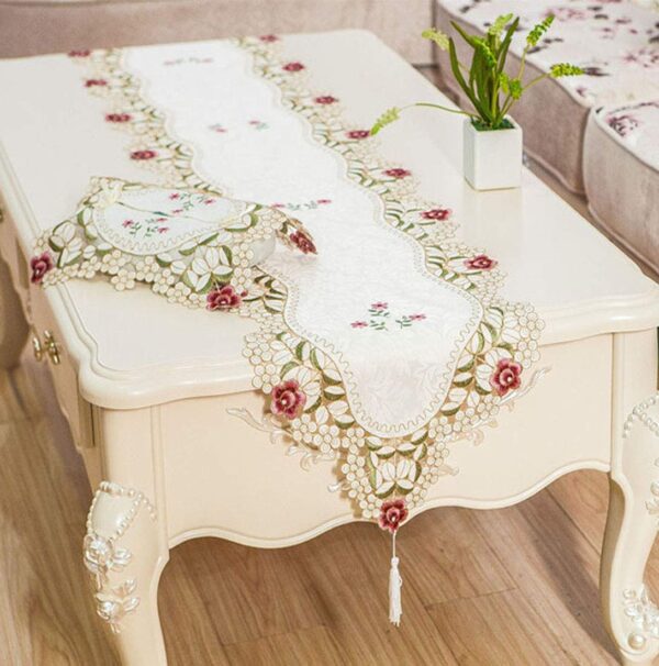 Decorative satin table runner with embroidered flowers and lace trim