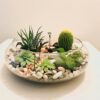 Decorative glass bowl uruli with floating flowers and candles
