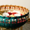 Hand-painted decorative urli bowl with metal stand