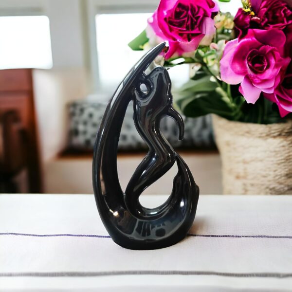 Artistic black finish mermaid figurine holding fish sculpture