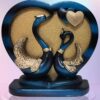 Love-inspired swan statue couple with heart-shaped frame