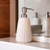 Beautiful ceramic bathroom accessory set with dispenser and holder.