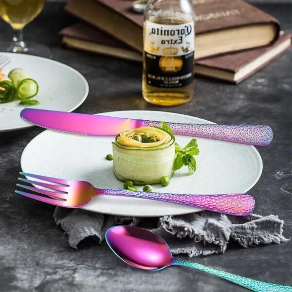 Mirror finished stainless steel cutlery set arranged neatly on tablecloth