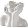 Small white ceramic vase with abstract face design for tabletop decoration