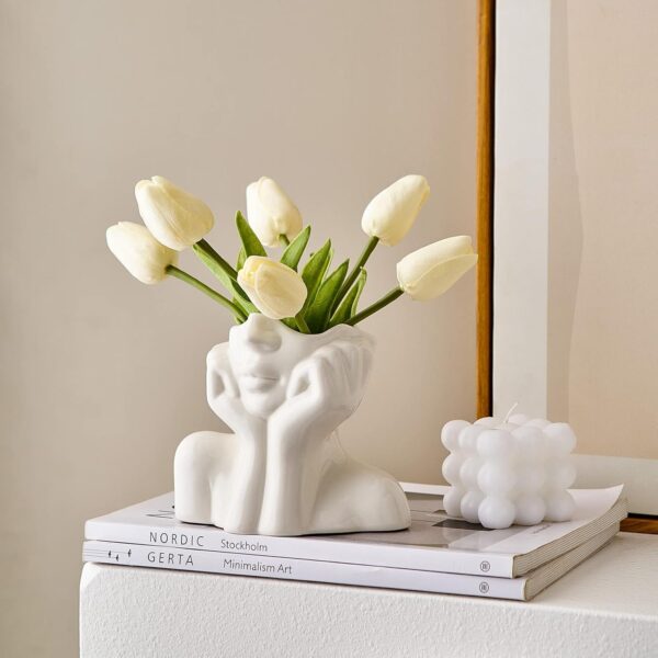 Small white ceramic face flower vase enhancing modern home aesthetics