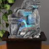 Small tabletop resin fountain with calming water flow for home décor