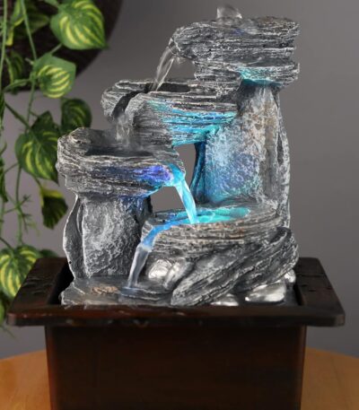 Small tabletop resin fountain with calming water flow for home décor