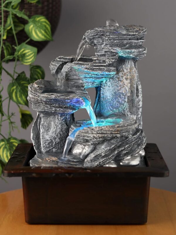 Small tabletop resin fountain with calming water flow for home décor