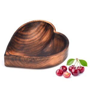 Close-up of wooden heart shape serving bowl for fruits and snacks