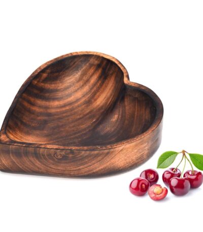 Close-up of wooden heart shape serving bowl for fruits and snacks