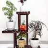 Wooden plant stand with multiple tiers for indoor plants