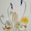 Handcrafted artistic yellow glass swan sculpture with tree accent
