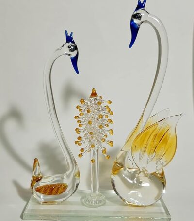 Handcrafted artistic yellow glass swan sculpture with tree accent