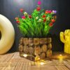 Artificial flowering plant in wood texture pot for home decor