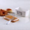 Airtight butter dish with smooth wooden cover placed on countertop