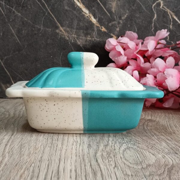 Smooth finish ceramic butter holder displayed on dining table