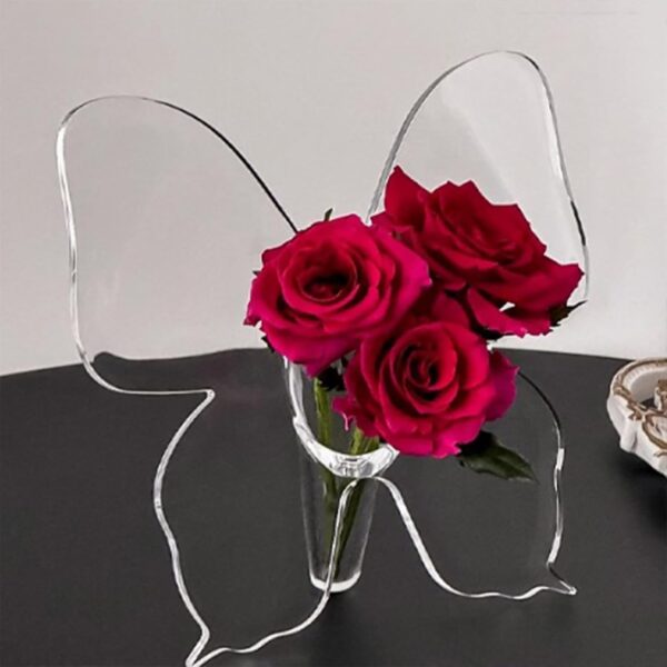 Clear acrylic butterfly vase for flowers on tabletop