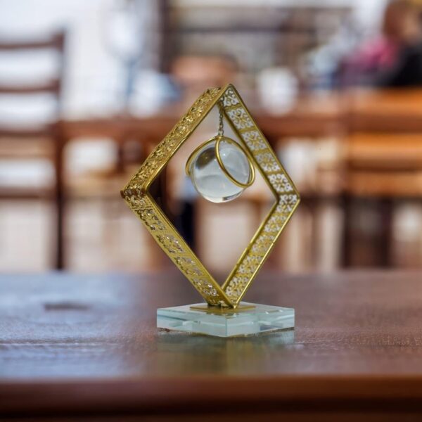 Decorative crystal sphere art piece with gold finish and soft illumination
