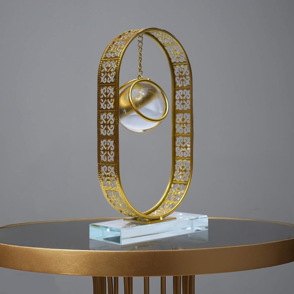 Clear crystal ball ornament displayed on a gold metal stand for elegant home décor