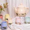 Bright colorful ceramic tea cup and kettle handcrafted set
