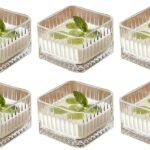 Square glass dessert bowl filled with ice cream on wooden table