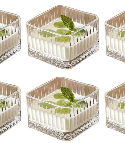 Square glass dessert bowl filled with ice cream on wooden table