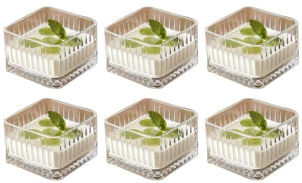 Square glass dessert bowl filled with ice cream on wooden table