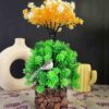 Small fake plants with multicolor artificial flowers in coconut wooden pot