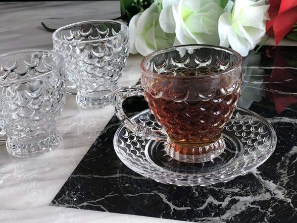 Elegant transparent glass tea cup and saucer for hot beverages