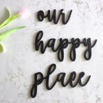 Matt black “Our Happy Place” wooden round wall hanging décor