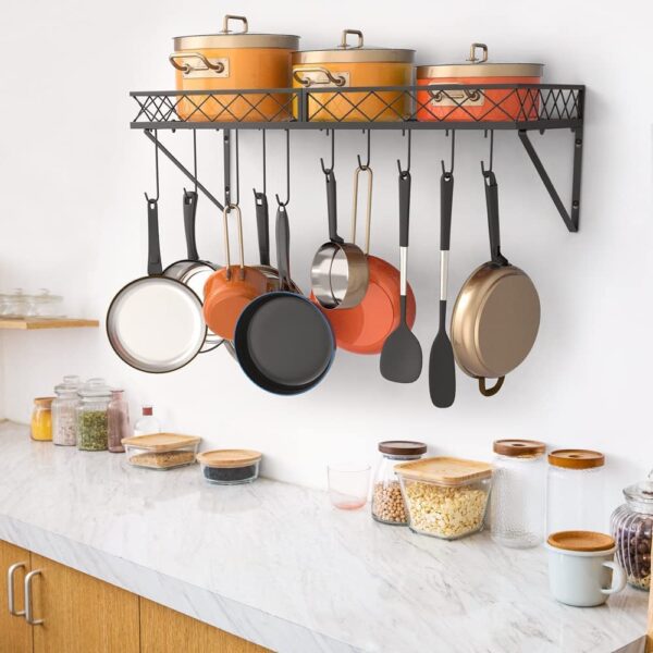 Black metal kitchen rack mounted on wall organizing pots and pans